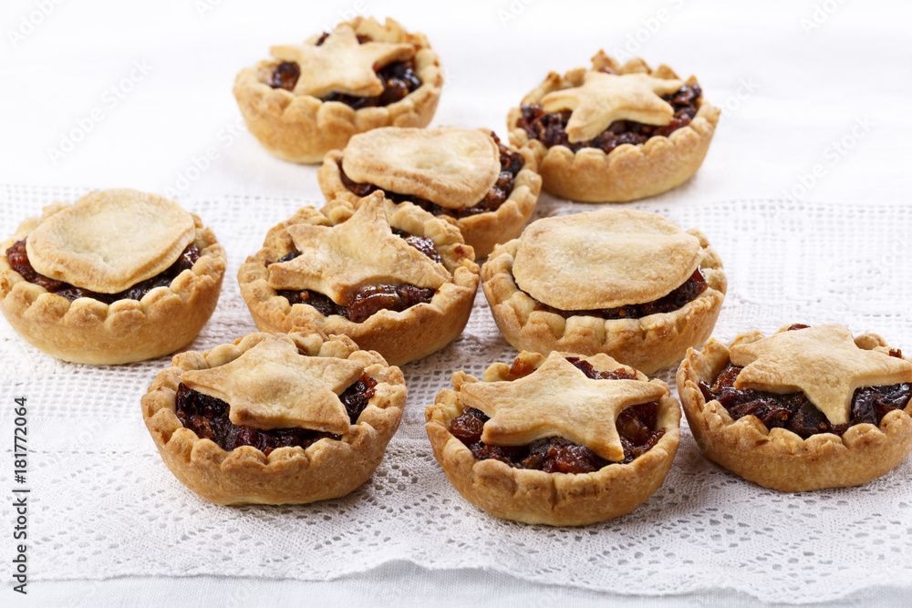 Traditional homemade fruit mince pies on white.