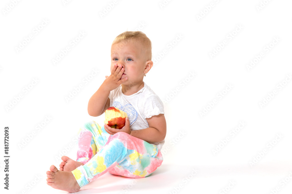 Cool toddler girl is holding a red apple Cool toddler girl is holding a red apple