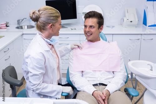 Patient looking at dentist at medical clinic