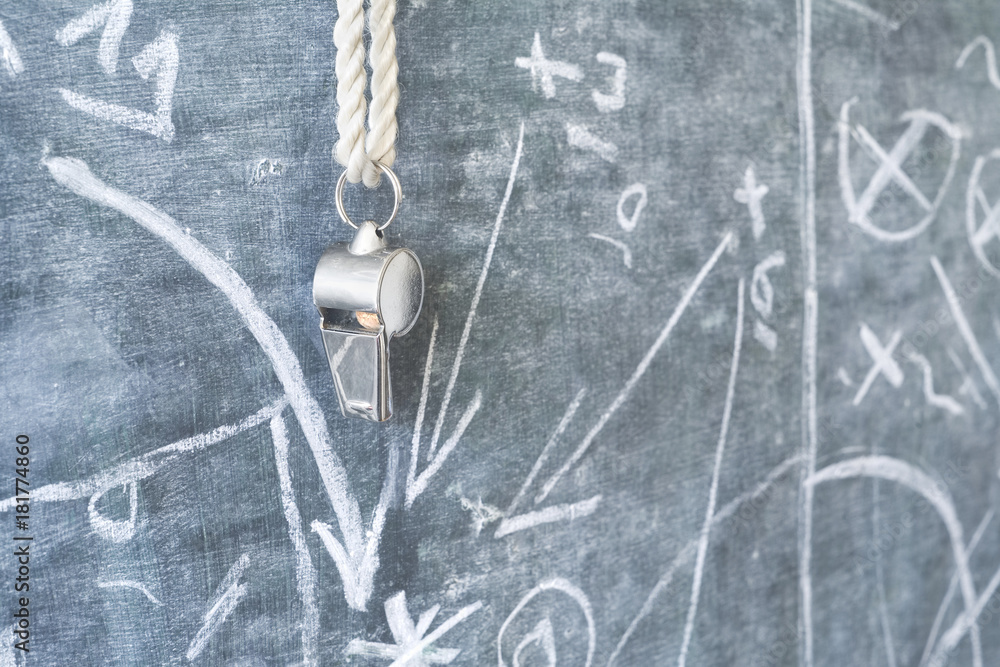 whistle of a soccer coach / referee on black board with strategy drawing