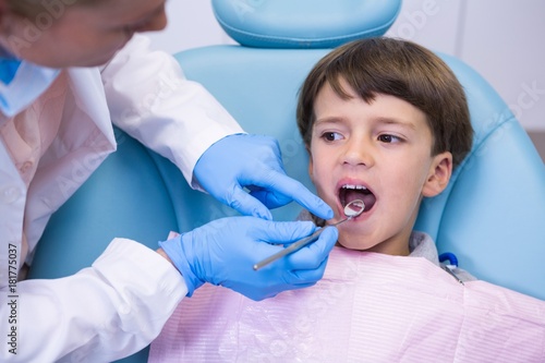 Dentist examining boy at clinic