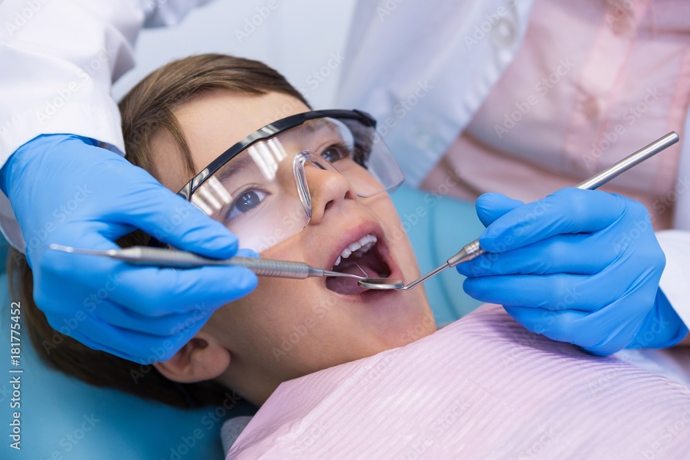Boy wearing eyewear taking dental treatment Boy wearing eyewear taking dental treatment