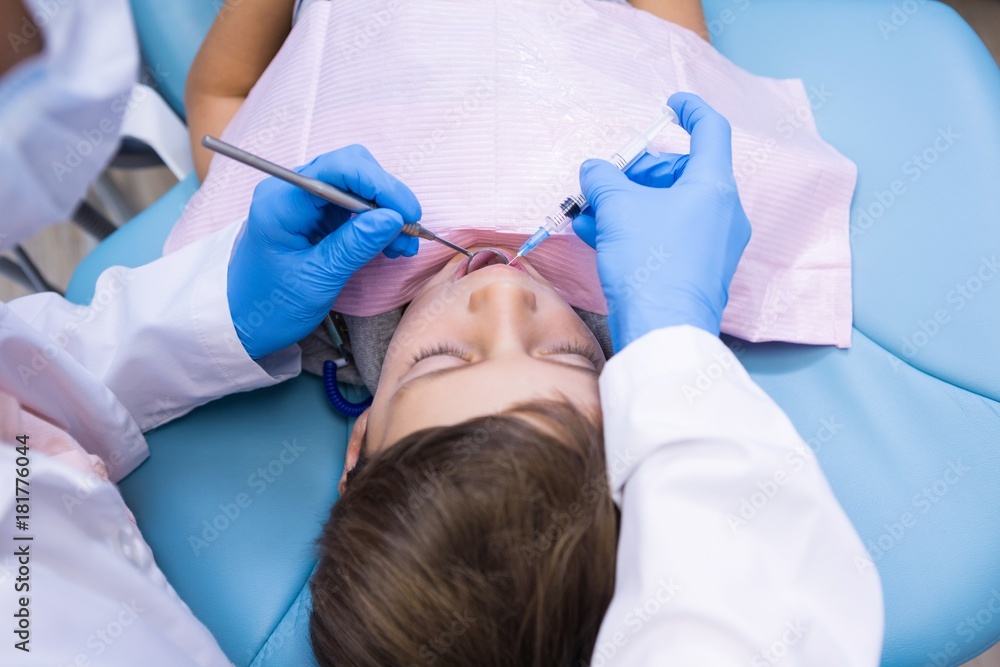 High angle view of dentist holding medical equipment while High angle view of dentist holding medical equipment while