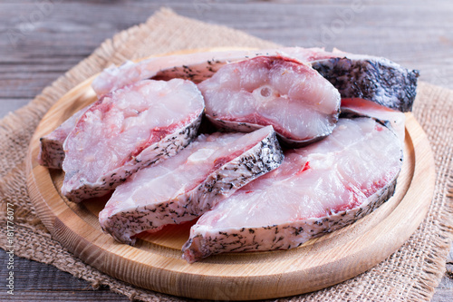 Slices of raw fresh fish on a cutting board