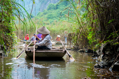 Bamboo tourist boat in tam coc caves at Natural Reserve of Van Long wetlands. Van Long Lagoon is attractive eco tourism site for tourists in Gia Vien district Ninh Binh, Vietnam