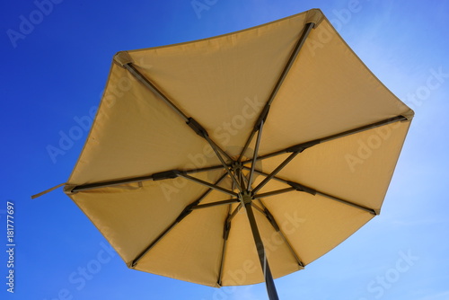Looking up towards the sky under a sun umbrella