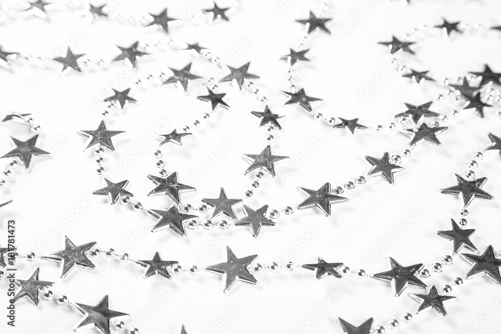 Fototapeta premium Christmas background with silver stars decorations on white. Simple Christmas composition with copy space