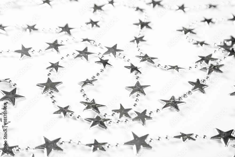Christmas background with silver stars decorations on white. Simple Christmas composition with copy space Christmas background with silver stars decorations on white. Simple Christmas composition with copy space