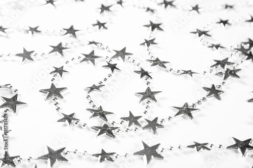 Christmas background with silver stars decorations on white. Simple Christmas composition with copy space