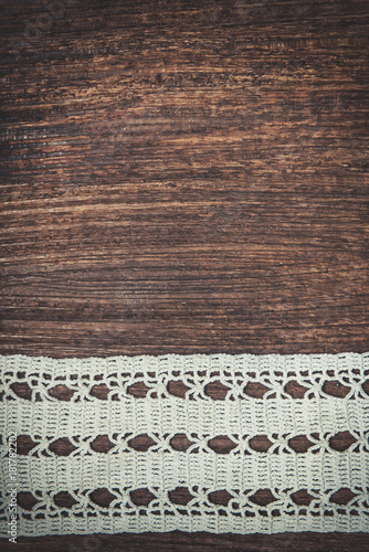 Vintage background with lace on the old wood
