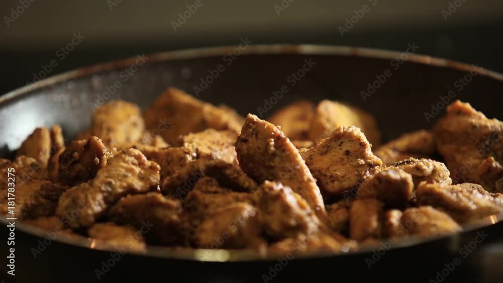 Meat fillet in a frying pan closeup in a frying pan with spices try with a fork Meat fillet in a frying pan closeup in a frying pan with spices try with a fork