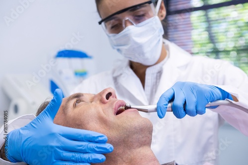 Close up of man receiving dental treatment by dentist