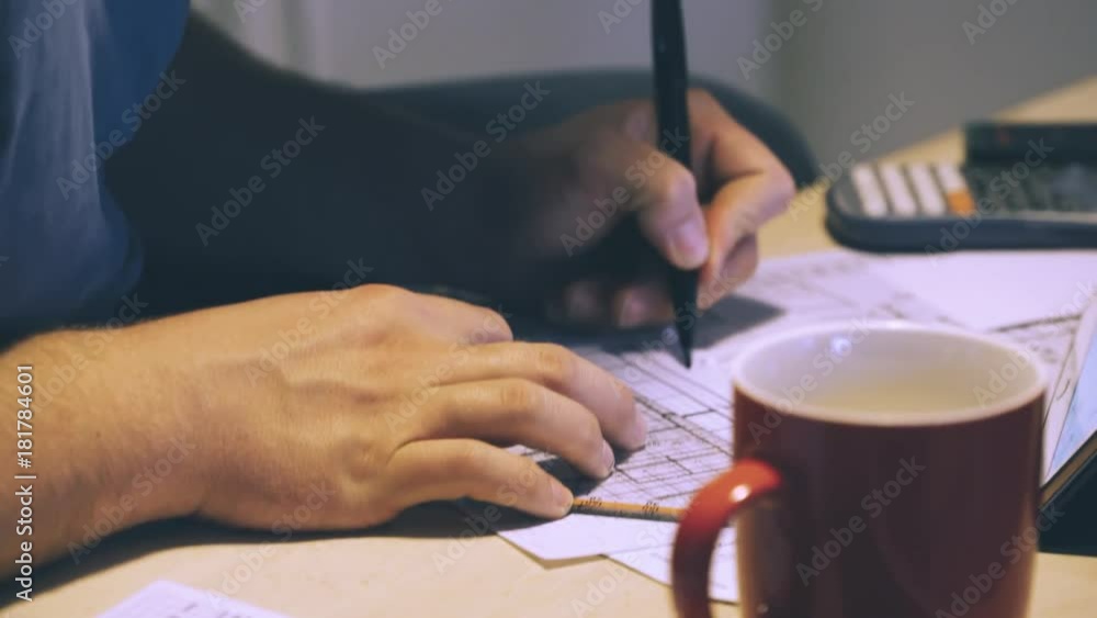 young man study on tablet pc in home office kitchen young man study on tablet pc in home office kitchen