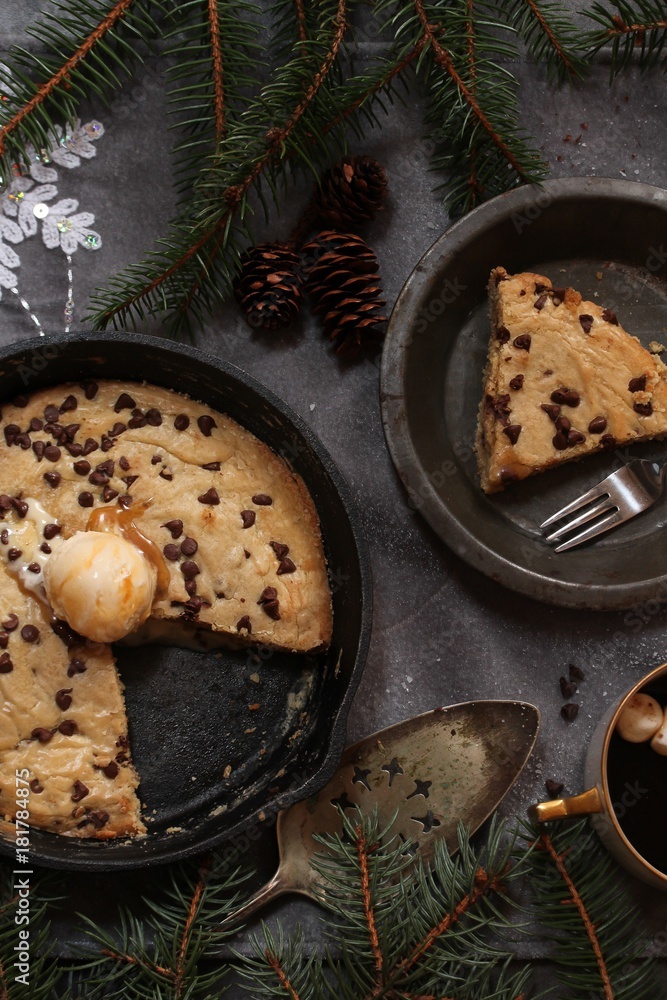 Fototapeta premium Homemade Skillet Chocolate chip cookie with a Dollop of ice cream ,top view