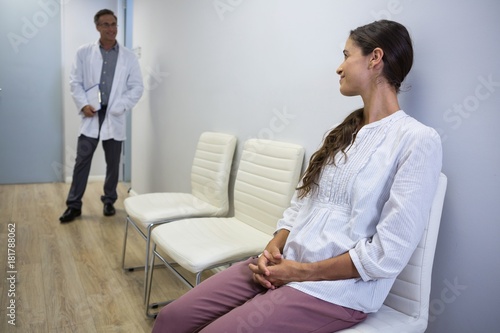 Woman looking at dentist while sitting on chair