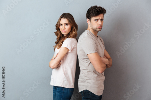 Fotografie Portrait of an upset sad couple standing back to back