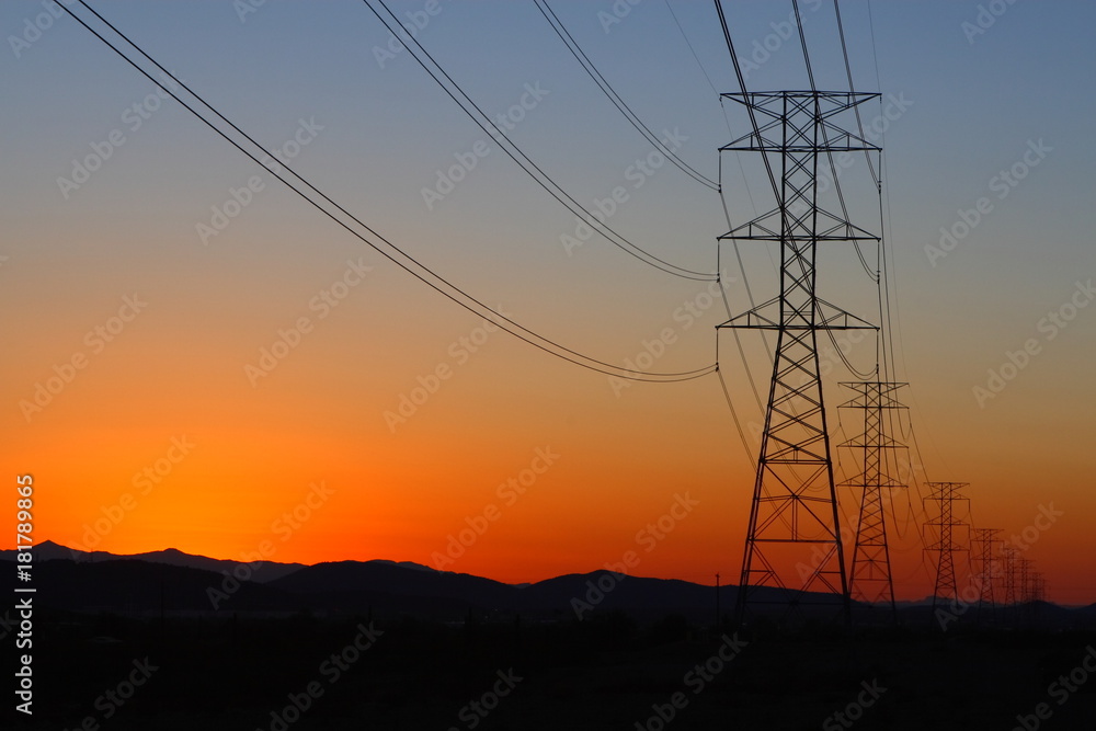High-power electric distribution tower at sunset
