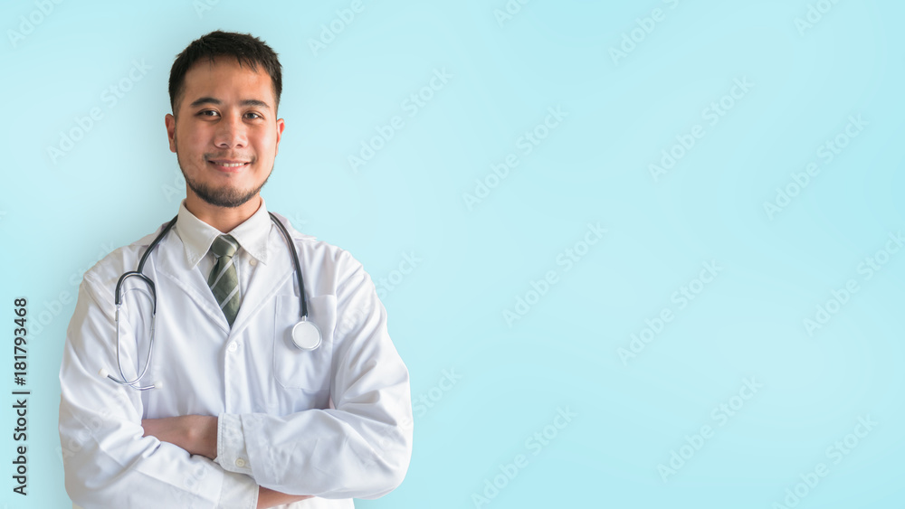 The portrait of an Asian young medical doctor in uniform with stethoscope, isolated on blue background with clipping path The portrait of an Asian young medical doctor in uniform with stethoscope, isolated on blue background with clipping path