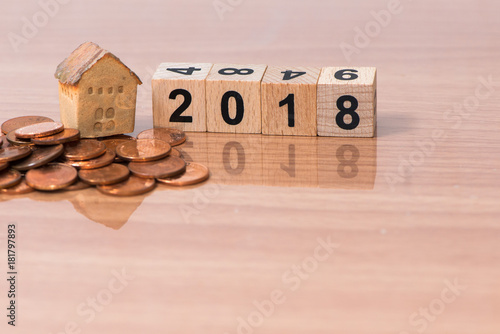 The wooden cube for new year with the house model and coins