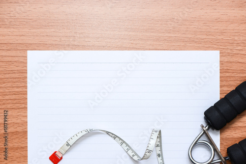 White line paper with sport equipments on wooden table