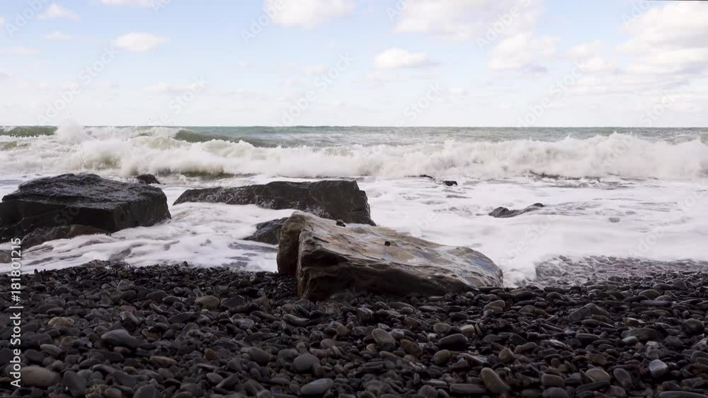 Large storm waves splashed on square boulders on a pebbled beach audio Large storm waves splashed on square boulders on a pebbled beach audio