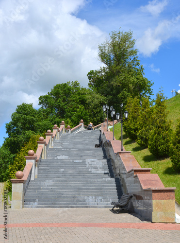 Beautiful staircase among green trees against the blue sky, climb, steps to the sky © alex2016