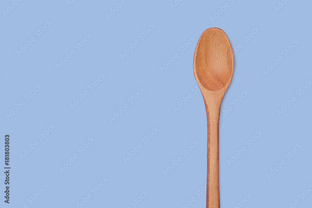 wooden spoon isolated on blue color background wooden spoon isolated on blue color background
