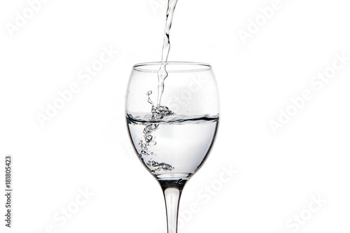 Wineglass with splashing drops of fresh water