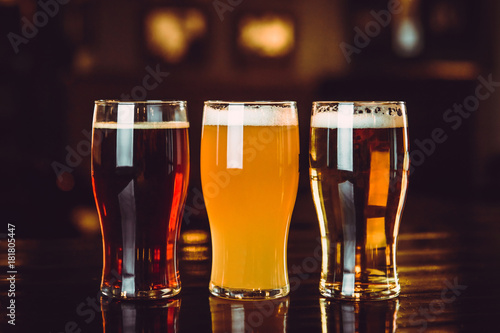Glasses of light and dark beer on a pub background