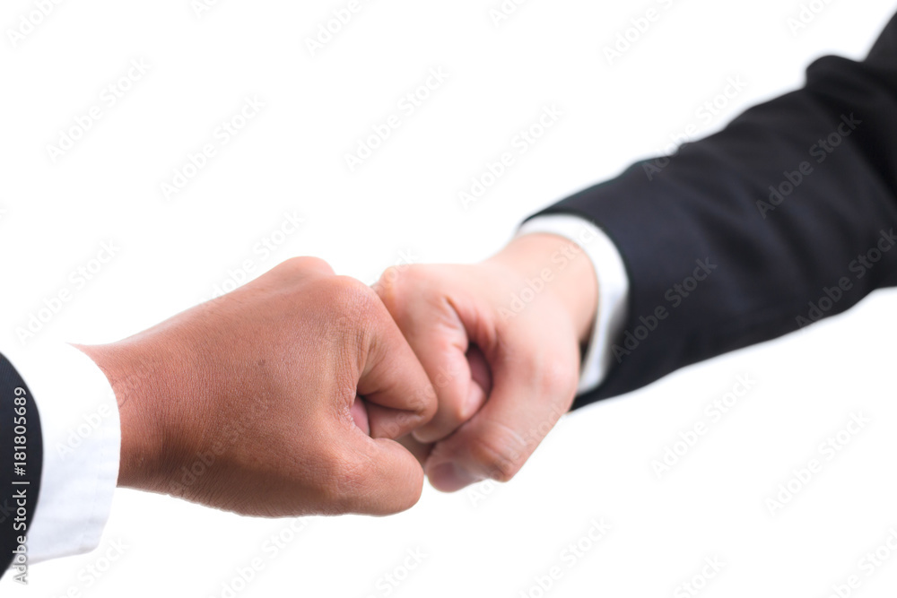 Close up of young asian businessman making a fist bump on white background. Business people wear suit do a fist pump together after good deal. Business success and teamwork concept.