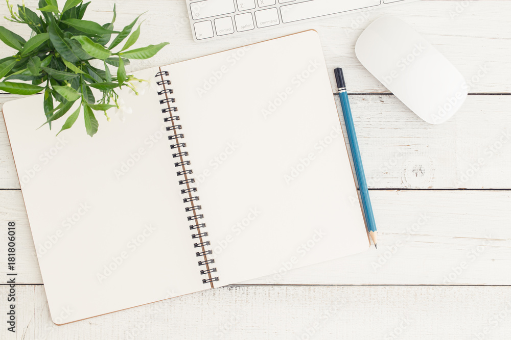 Flat lay photo of office desk with mouse and keyboard,Empty open notebook on white wood table top view Flat lay photo of office desk with mouse and keyboard,Empty open notebook on white wood table top view