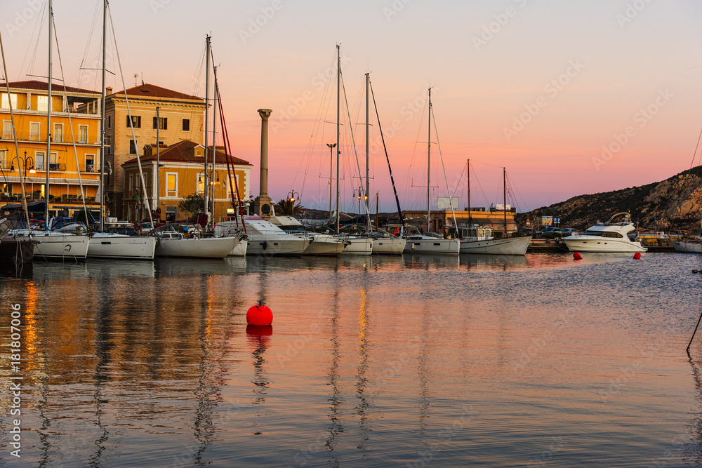 Boats in La Maddalena harbor at sunset