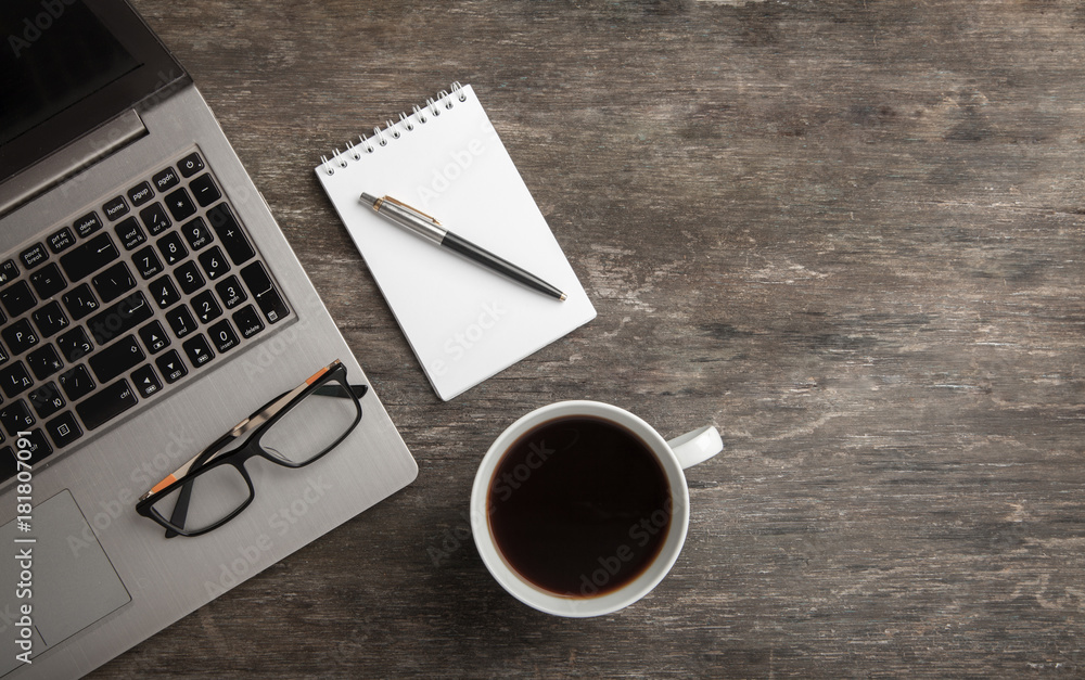 Top view of notebook, notepad, glasses and coffee. Business still life on old wooden table Top view of notebook, notepad, glasses and coffee. Business still life on old wooden table