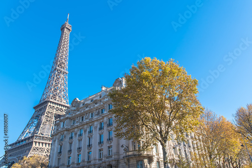 Paris, Eiffel tower, panorama, near typical facade in a chic area of the capital 