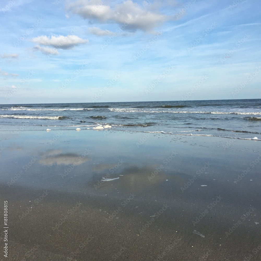 Beach with Clouds reflecting off of wet sand