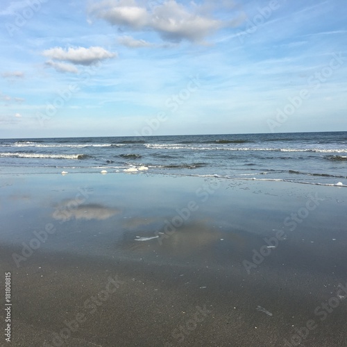 Beach with Clouds reflecting off of wet sand © Amanda