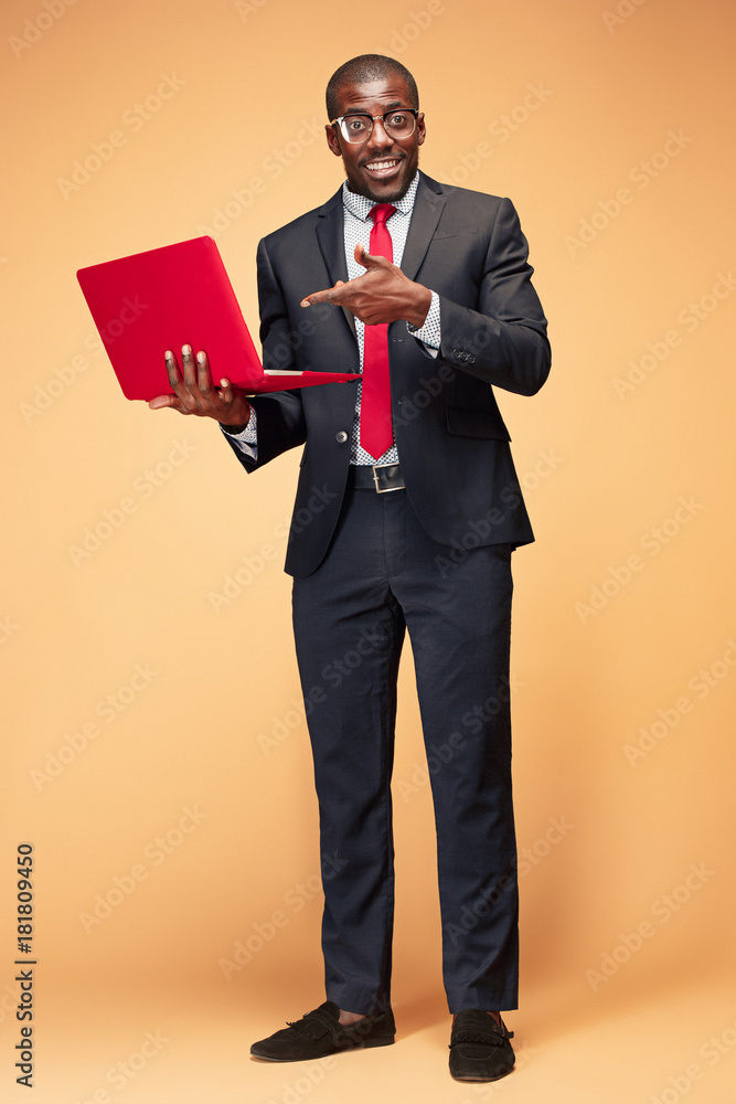 Handsome Afro American man sitting and using a laptop Handsome Afro American man sitting and using a laptop