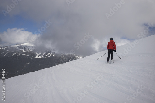 Tourist skiing on snowy mountain, Whistler, British Columbia, Canada