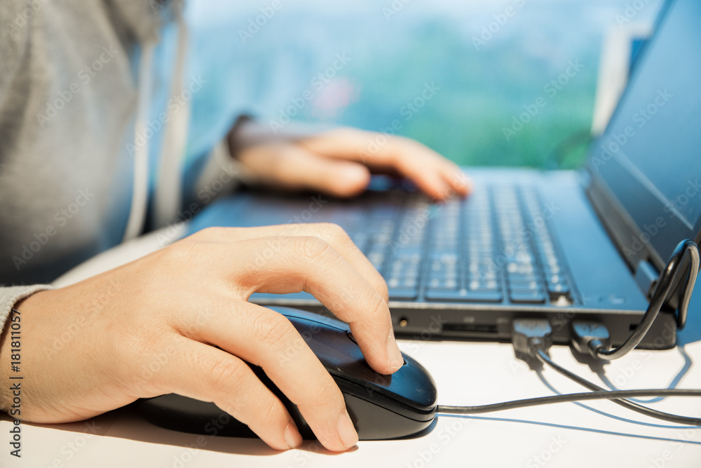 Closeup photo of female hands typing text on laptop keyboard. Business woman working at the office. Closeup photo of female hands typing text on laptop keyboard. Business woman working at the office.