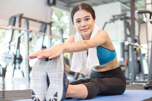 Portrait of Attractive young Asian Woman worm up before exercise at Fitness Club.