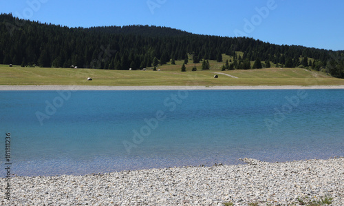 beautiful alpine pond with crystal clear water and mountains