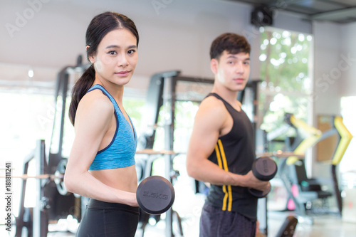 Portrait of People exercise at gym, People holding dumbbell for exercise at gym.