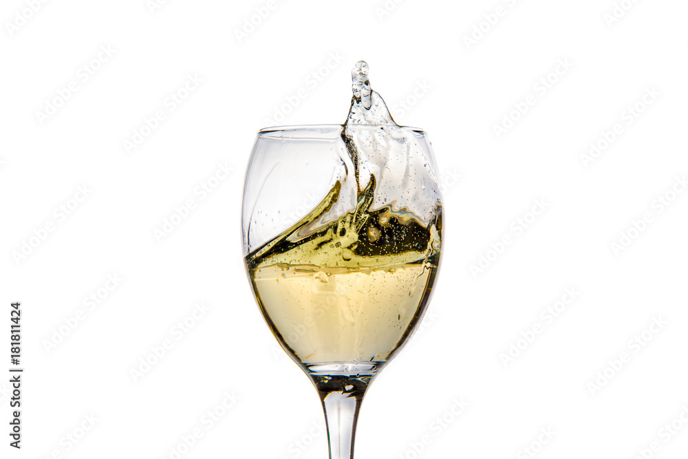 Wineglass with splashing drops of champagne