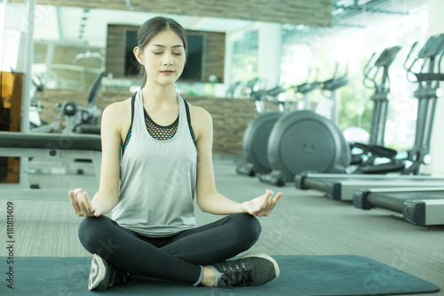 Portrait of Attractive Asian Girl doing Yoga exercise in gym