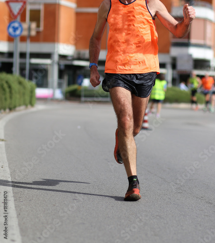 legs of runner while he runs at marathon race