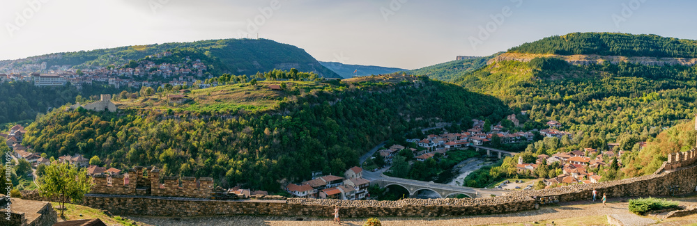 Panoramic view of Veliko Tarnovo from Tsarevets hill. Medieval ruins of Tsarevets fortress and typical terrace architecture in Veliko Tarnovo, Bulgaria