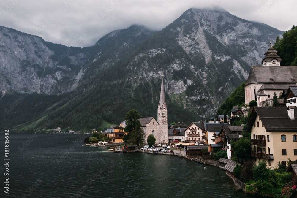 Fototapeta premium Scenic view of famous Hallstatt lakeside town reflecting in Hallstattersee lake in the Austrian Alps, Austria