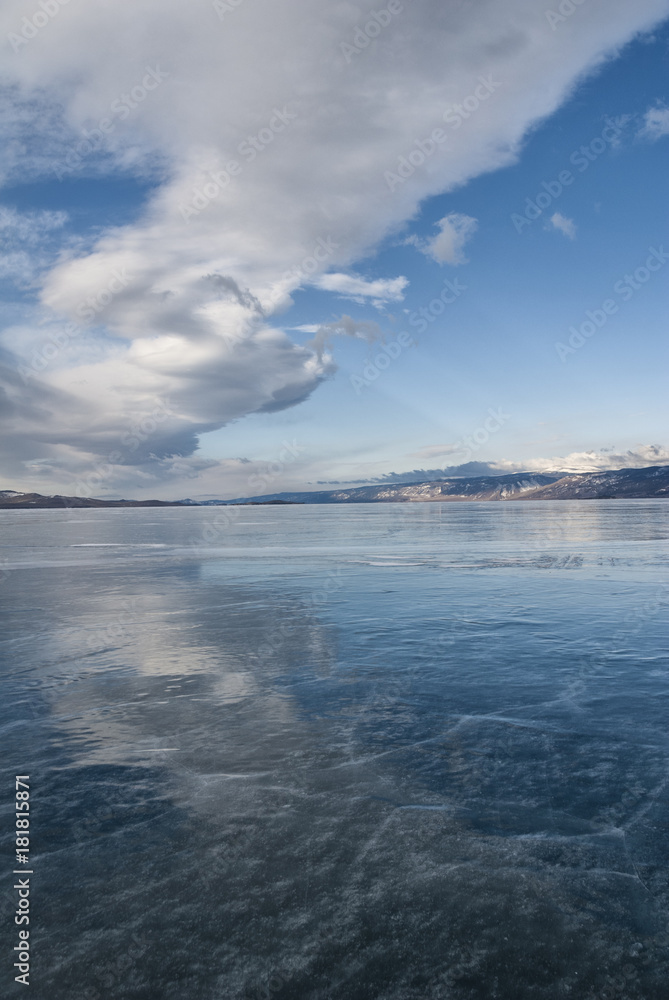 a big white cloud reflected in the transparent ice of Baikal