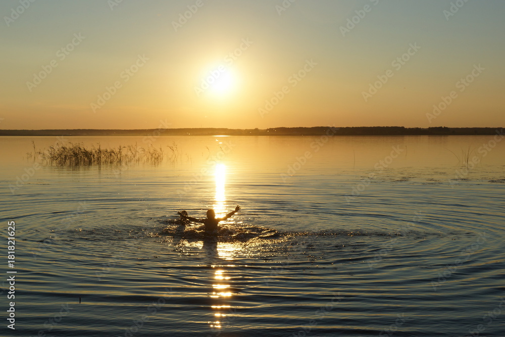 bathing in the golden lake sun setting sun set