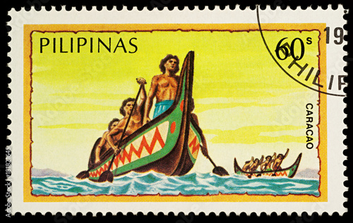 Group of the natives in traditional boat (caracao)